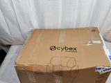 a box that is sitting on a bed with a white sheet