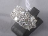 an image of a diamond ring on a black stand