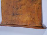 a wooden shelf with a clock on top of it