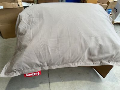 a pillow that is sitting on top of a cardboard box