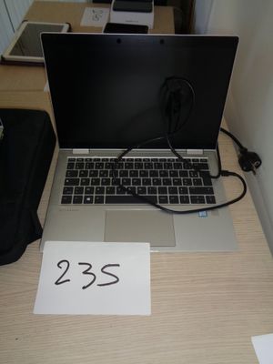 a laptop that is sitting on a desk with a number on it