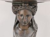an image of a statue of a woman with a bowl on top of her head