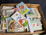 a cardboard box filled with lots of cards on a table