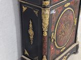 a black and gold cabinet with a marble top