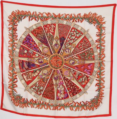a red and white scarf with a circular design on it