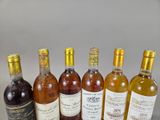 bottles of wine are lined up in a row on a table