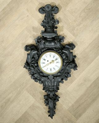a clock that is on the wall on the floor