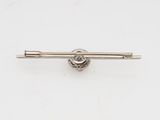 an image of a silver tie bar on a white surface