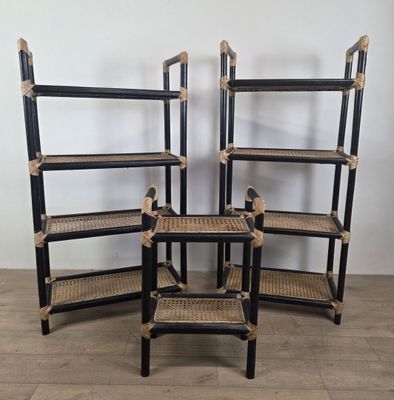 three black and wicker bookshelves are stacked on top of each other