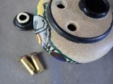 a picture of a vase with bullet shells on the ground