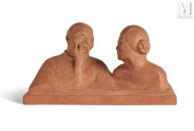 two figurines of a man and a woman sitting next to each other