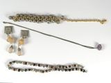 a lot of jewelry on a white surface