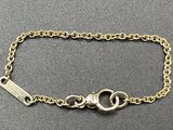 a close up of a chain bracelet with two rings on it
