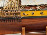 a wooden model of a ship on display on a table