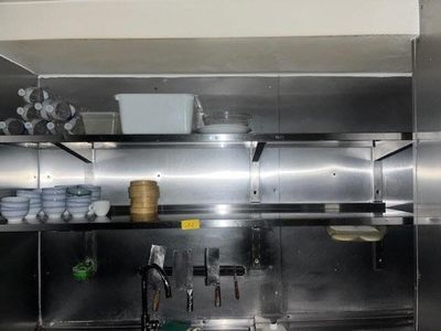 une cuisine équipée d'armoires en inox et d'un évier