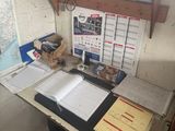 a desk with a lot of papers and a laptop on it
