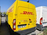 yellow dhl van parked next to a white van in a parking lot