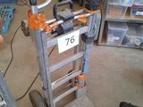a small hand truck with a number on it in a garage