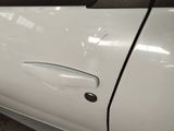 a close up of a car door handle with a sticker on it