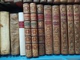 many old books on a blue shelf in a room