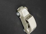 a toy car that is sitting on a black surface