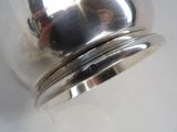 a silver object that is on a white surface