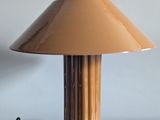 a table with a lamp on it on a white surface