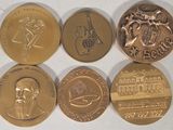 four different types of coins are shown on a white surface
