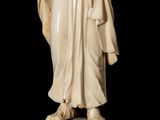 a statue of a man in a robe holding a staff