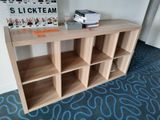 a shelf with books and magazines on it in a room