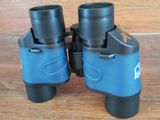 a pair of binoculars sitting on a wooden floor