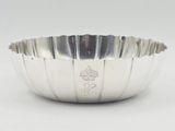 silver plated bowl with a flower design on the side