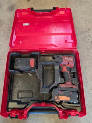 a red tool box filled with tools sitting on top of a cement floor
