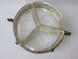 a silver plate with four sections on it on a table