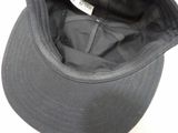 a black hat with a tag on it sitting on a table