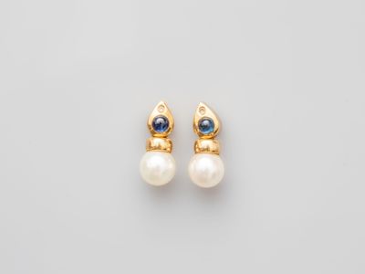 a pair of pearl and gold earrings