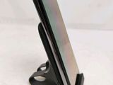 a phone that is sitting on a stand on the table