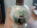 a vase on a table with a picture of a woman on it