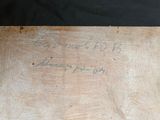a piece of wood that has writing on it