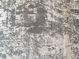 a close up of a white and black rug on a wooden floor