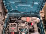 a blue tool box with tools in it sitting on the floor