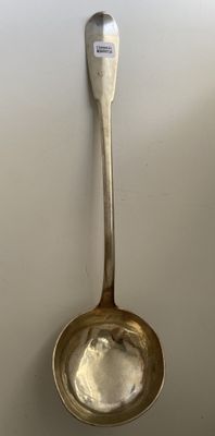 a spoon that is hanging on the wall with a spoon in it
