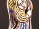 an image of a ceramic figurine of a woman on a table