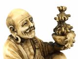 a figurine of a man holding a pot of flowers