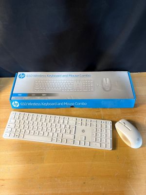 a computer keyboard and a mouse on a table