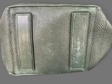 grey leather purse with two zippers on the inside of it