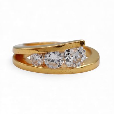 an image of a three stone diamond ring on a white background