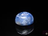 a picture of a blue and white marble on a black surface