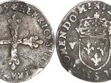 a close up of a coin with a cross on it