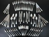 a lot of forks and spoons arranged in a circle